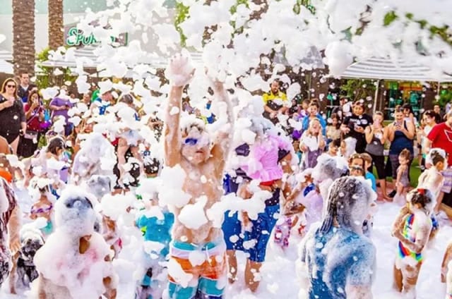 Crowd enjoying an outdoor foam party event